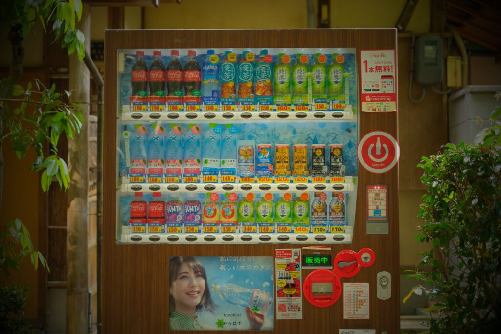 A colorful vending machine in Japan displaying various drinks and snacks.